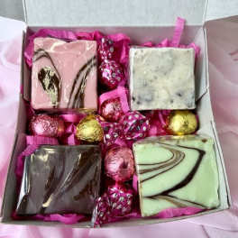 Box of assorted chocolates with pink and gold foil-wrapped candies