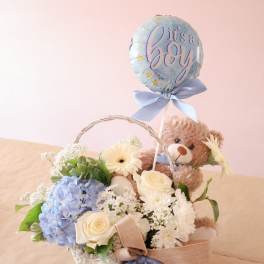 Flower basket with a teddy bear and a "it's a boy" balloon