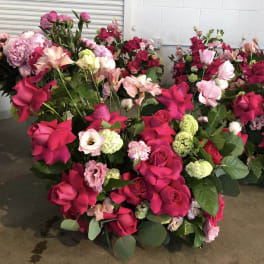 Assorted pink and red rose bouquets with carnations and lisianthus