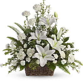 Basket arrangement of white lilies and white carnations