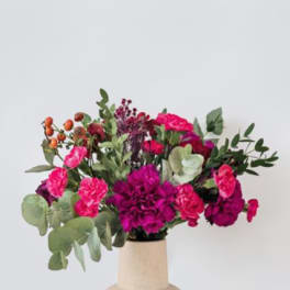 Pink and magenta bouquet in a beige vase