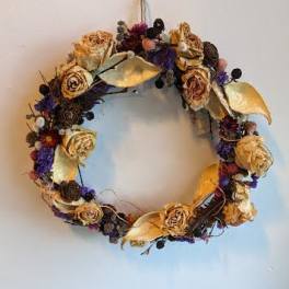 Dried floral wreath with beige roses and purple accents