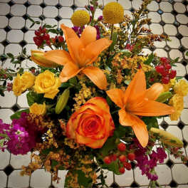 Bouquet with orange lilies, orange rose, yellow roses, and purple flowers