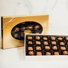 Boxes of assorted chocolates in gold and white packaging