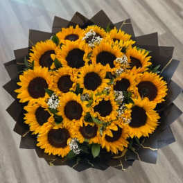 Bouquet of sunflowers wrapped in dark paper