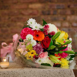 Mixed bouquet of colorful flowers wrapped in clear plastic