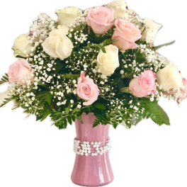 Pink and white roses in a pink vase with baby's breath
