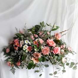 Large pink and white floral arrangement with roses and daisies
