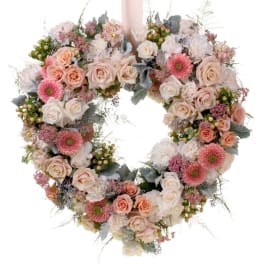 Heart-shaped floral wreath with pink and white roses and daisies