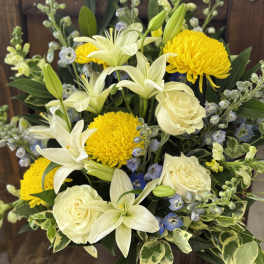 Bouquet of white lilies, cream roses, and yellow chrysanthemums