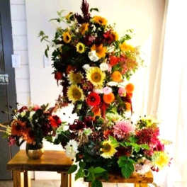 Large colorful floral arrangement with sunflowers and mixed blooms
