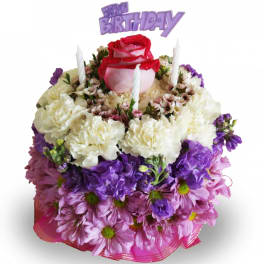 Birthday cake-shaped floral arrangement with purple and pink flowers