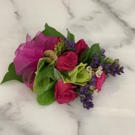 Pink rose bouquet with purple filler and green leaves