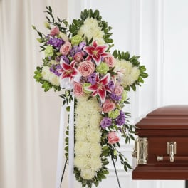 Standing funeral spray with pink lilies, roses, and white flowers