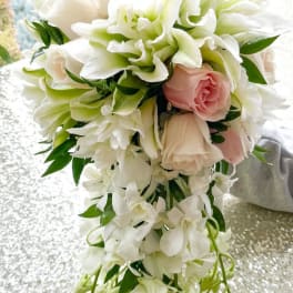 Cascade bouquet of white and blush flowers with trailing greenery