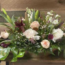 Mixed bouquet with pale roses, white blooms, and purple calla lilies