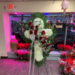 Standing floral spray with red roses and white chrysanthemums on an easel