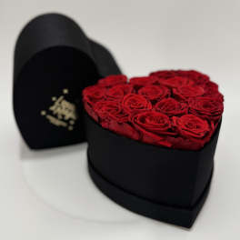 Heart-shaped box filled with red roses