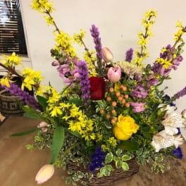 Mixed flower basket with yellow, purple, pink, and white blooms