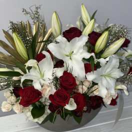 Red roses and white lilies in a gray vase