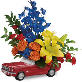 Flowers arranged in a red toy car container