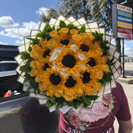 Bouquet of yellow sunflowers and roses wrapped in paper