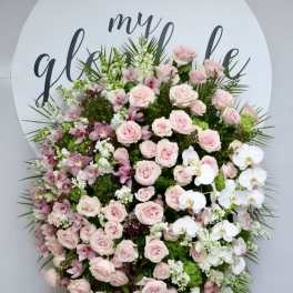 Large pink and white floral standing spray with roses and orchids