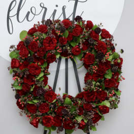 Red rose wreath on a black easel