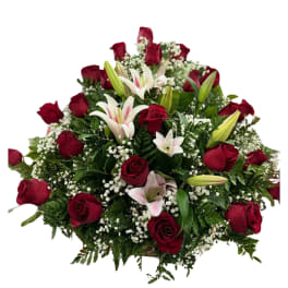 Red roses and white lilies arranged in a low bouquet