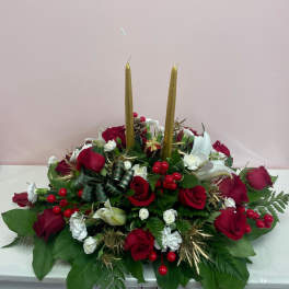 Red and white rose centerpiece with two gold taper candles