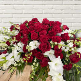 Large red and white floral arrangement with roses and lilies