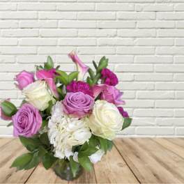 Bouquet of pink and white roses with hydrangea in a glass vase