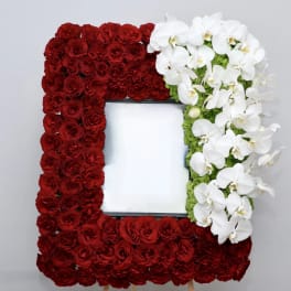 Rectangular floral frame with red roses and white orchids around a blank center