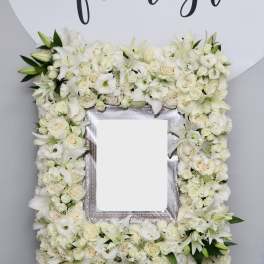 White floral frame arrangement around a blank center panel