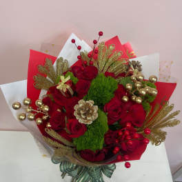 Red rose bouquet with gold accents and decorative wrapping