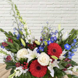 Mixed bouquet with red gerbera daisies, white roses, and lilies