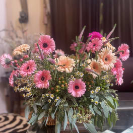 Pink and peach gerbera bouquet in a low basket arrangement