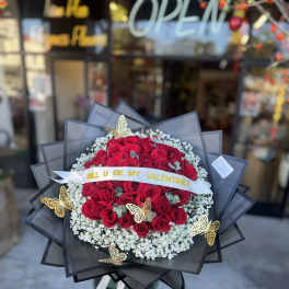 Large bouquet of red roses with white baby's breath and gold butterfly accents