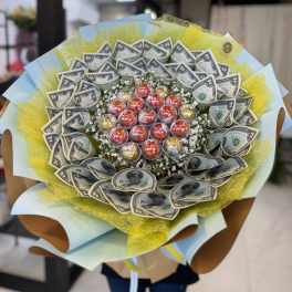 Bouquet of wrapped dollar bills with candy in the center