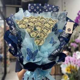 Blue gift bouquet with dollar-bill accents and butterfly decorations