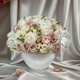 Blush and white rose bouquet in a white vase