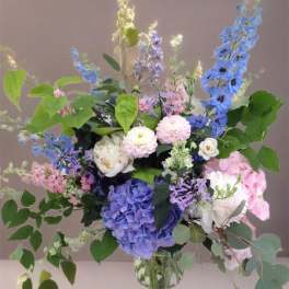 Mixed pastel flower arrangement in a clear glass vase