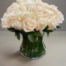 White rose bouquet in a clear glass vase