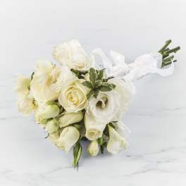 White rose and lisianthus bouquet tied with a white ribbon