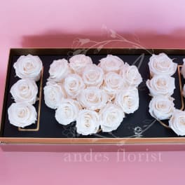 White roses arranged in a rectangular gift box