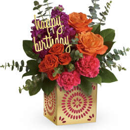 Birthday flower arrangement with roses, carnations, and a happy birthday sign