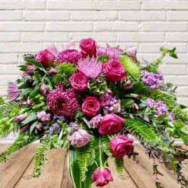Pink and purple floral arrangement in a glass vase