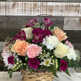 Mixed flower basket with roses, carnations, daisies, and alstroemeria