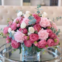 Pink and white rose bouquet in a clear glass vase