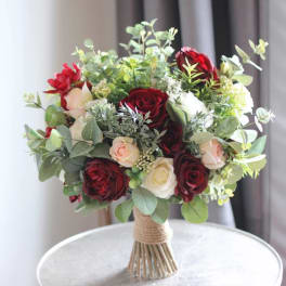 Bouquet of red, white, and blush roses with greenery